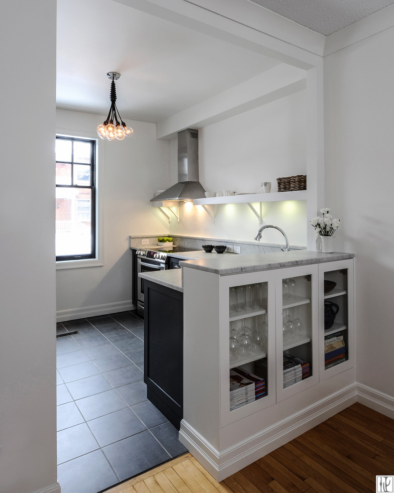 Photo of a small transitional l-shaped kitchen pantry in Ottawa with an undermount sink, shaker cabinets, black cabinets, marble benchtops, white splashback, stone slab splashback, stainless steel appliances, porcelain floors and a peninsula.