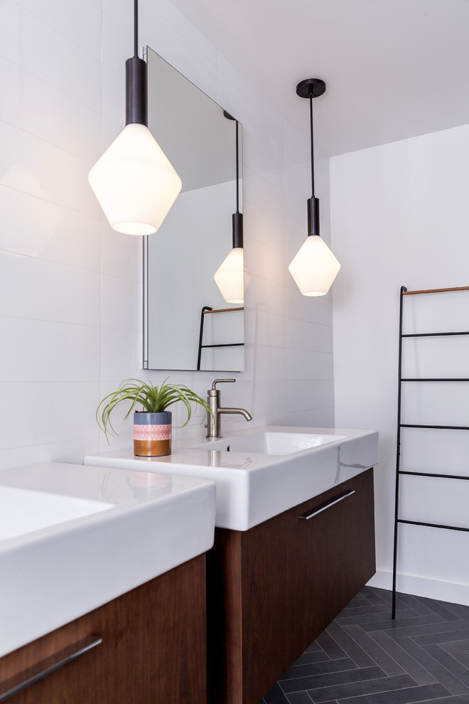 Photo of a contemporary bathroom in Boston with flat-panel cabinets, medium wood cabinets, white tile, white walls, a console sink and grey floor.
