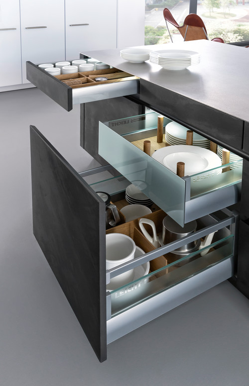 RTA base cabinet with adjustable peg drawer system organizing plates, bowls, and mugs