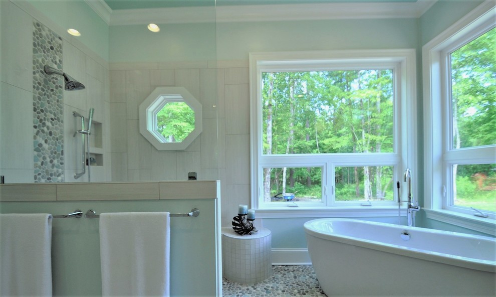 Photo of a large transitional master bathroom in Wilmington with recessed-panel cabinets, grey cabinets, a freestanding tub, a curbless shower, beige tile, pebble tile, green walls, ceramic floors, an undermount sink, limestone benchtops, beige floor, an open shower and multi-coloured benchtops.