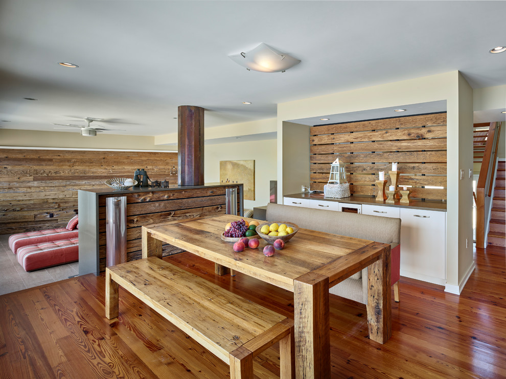 Example of a beach style medium tone wood floor great room design in New York with beige walls and no fireplace