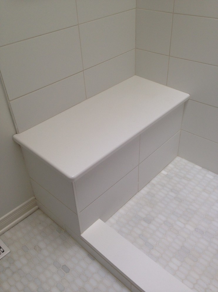 This is an example of a small modern master bathroom in Ottawa with flat-panel cabinets, medium wood cabinets, an alcove shower, a one-piece toilet, white tile, mosaic tile, white walls, marble floors, an undermount sink and engineered quartz benchtops.