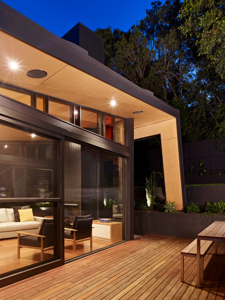 Inspiration for a large contemporary two-storey black exterior in Melbourne with metal siding and a gable roof.