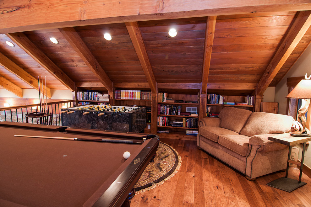 Design ideas for a mid-sized country loft-style family room in Denver with a game room, beige walls and medium hardwood floors.