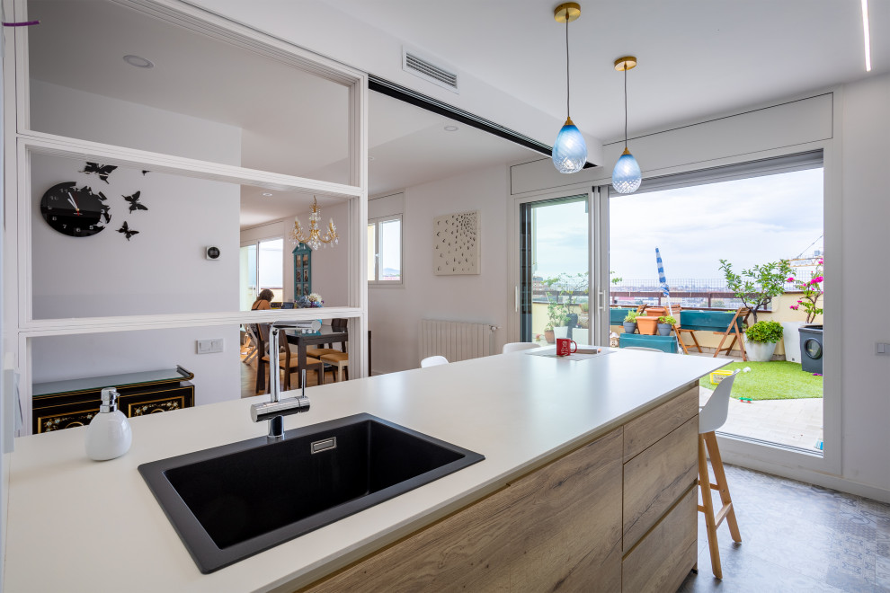 Mid-sized scandinavian u-shaped open plan kitchen in Barcelona with a single-bowl sink, flat-panel cabinets, white cabinets, beige splashback, stainless steel appliances, a peninsula, multi-coloured floor and beige benchtop.