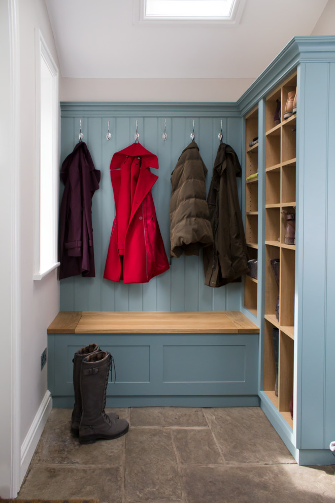 Photo of a small traditional entryway in Manchester with white walls, limestone floors and grey floor.