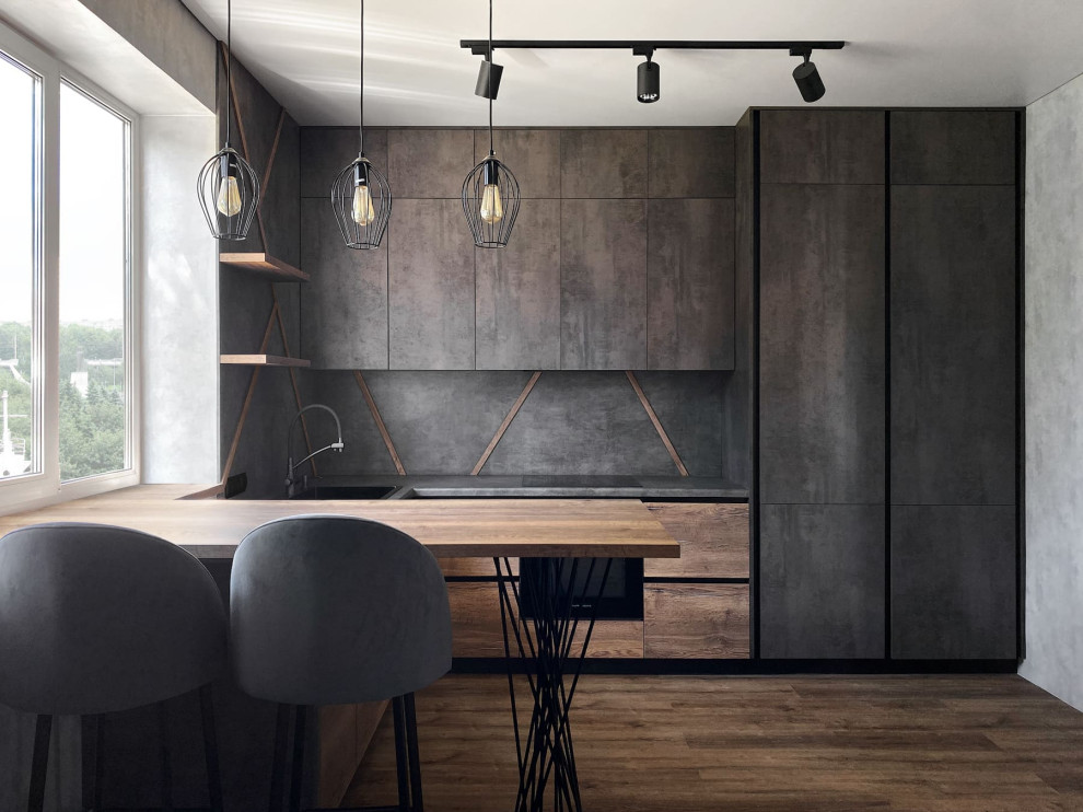 Photo of a medium sized industrial l-shaped enclosed kitchen in Other with a built-in sink, raised-panel cabinets, grey cabinets, wood worktops, grey splashback, wood splashback, stainless steel appliances, laminate floors, a breakfast bar, brown floors and brown worktops.