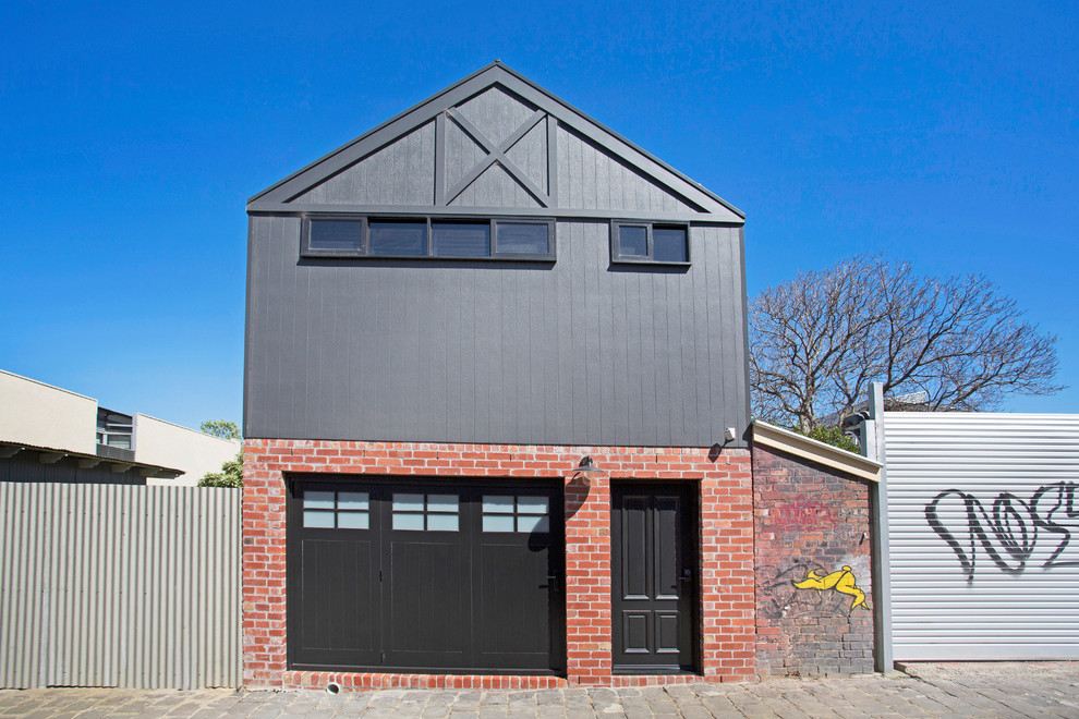 Photo of a transitional two-storey grey house exterior in Melbourne with mixed siding and a gable roof.