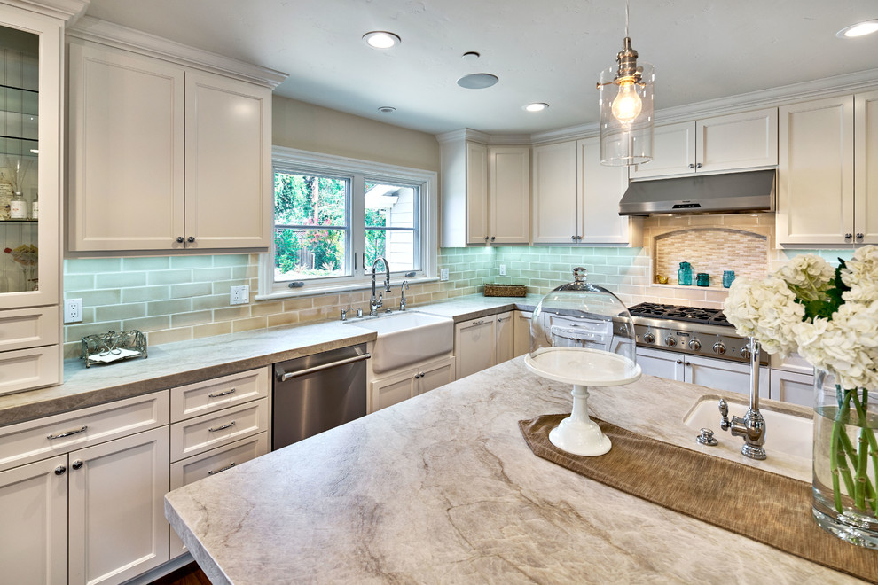 Photo of a large traditional l-shaped open plan kitchen in San Francisco with a farmhouse sink, shaker cabinets, white cabinets, quartzite benchtops, white splashback, subway tile splashback, stainless steel appliances, dark hardwood floors and with island.