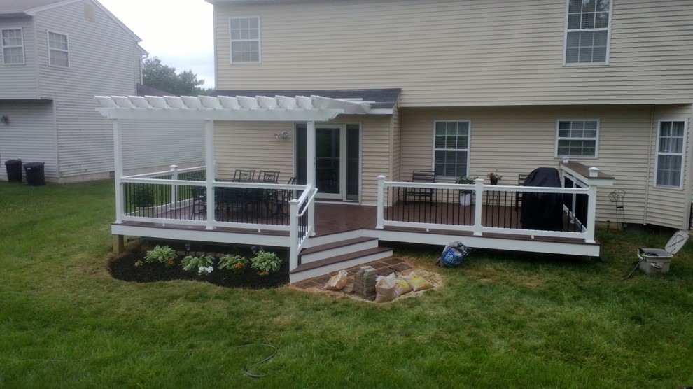 Mid-sized traditional backyard deck in Baltimore with a pergola.