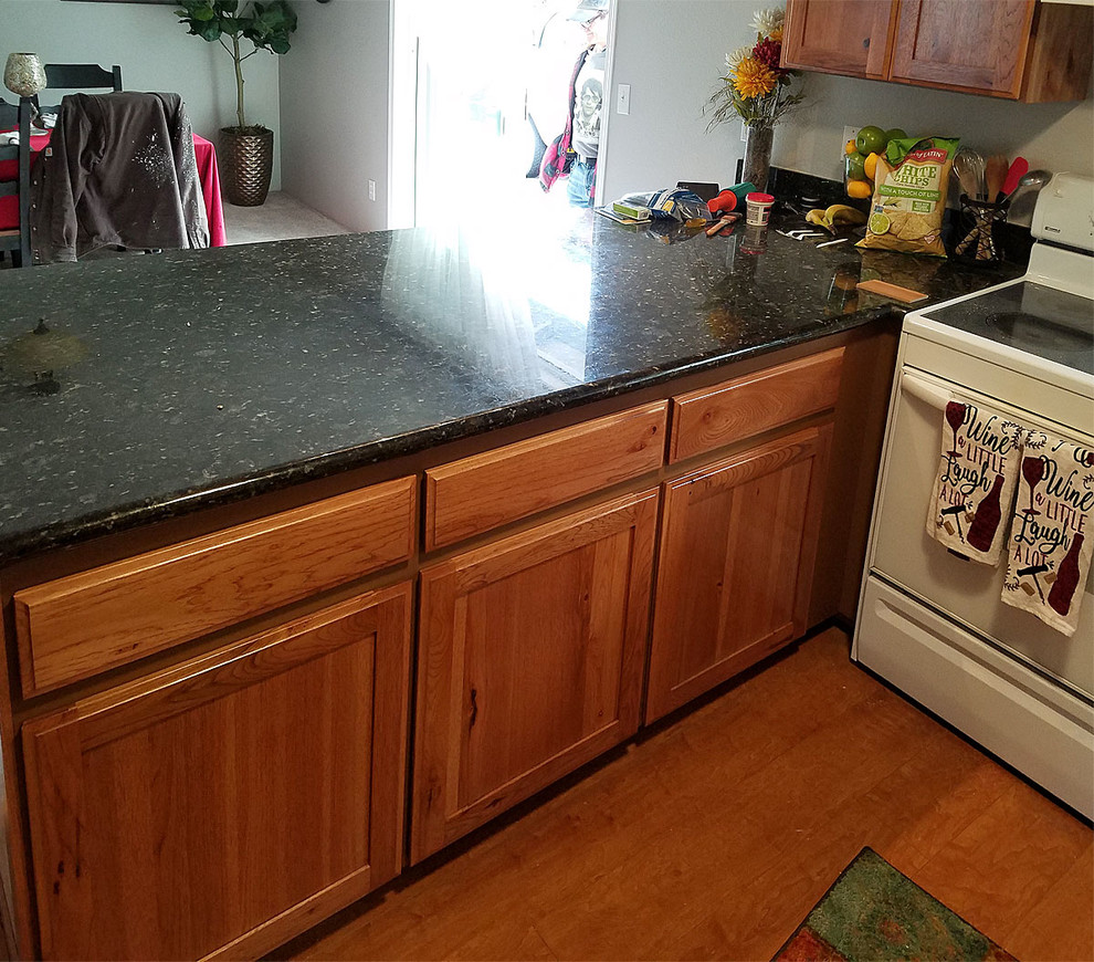 Inspiration for a large u-shaped brown floor kitchen remodel with shaker cabinets and no island