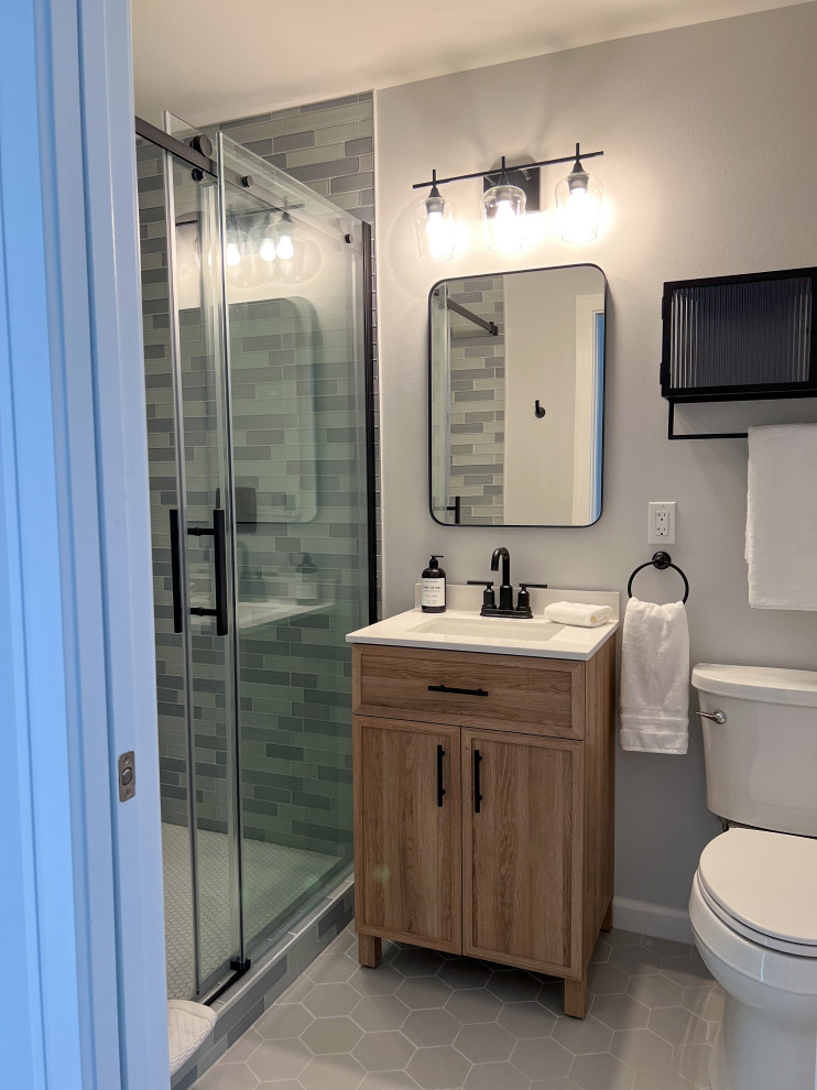 Bild på ett litet funkis vit vitt badrum med dusch, med skåp i shakerstil, skåp i mellenmörkt trä, blå kakel, glaskakel, grå väggar, klinkergolv i porslin, ett undermonterad handfat, grått golv och dusch med skjutdörr