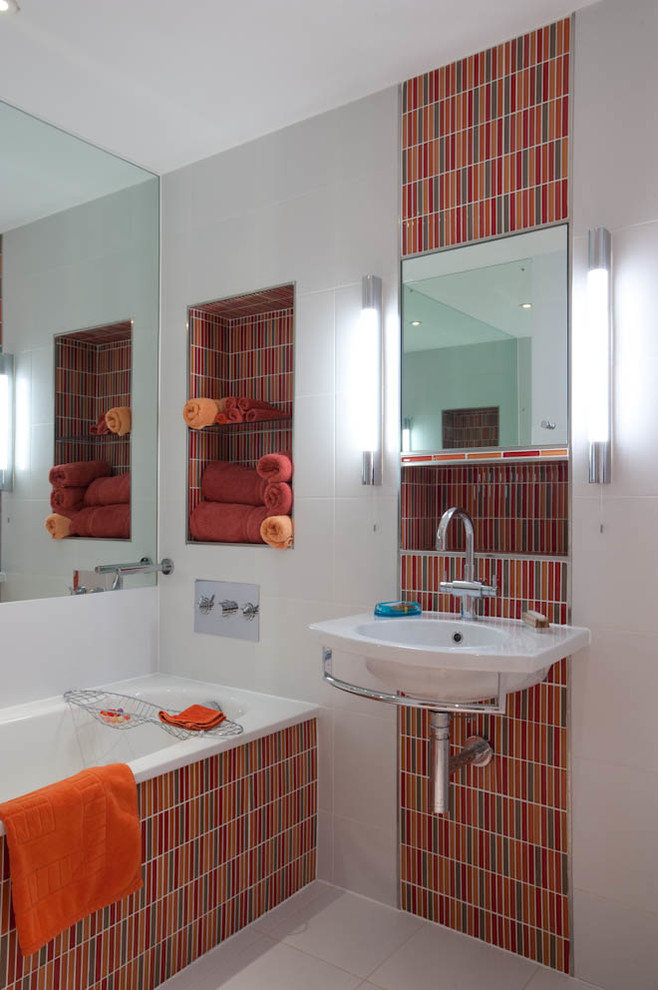 Contemporary bathroom in Kent with a wall-mount sink, an alcove tub, multi-coloured tile and mosaic tile.