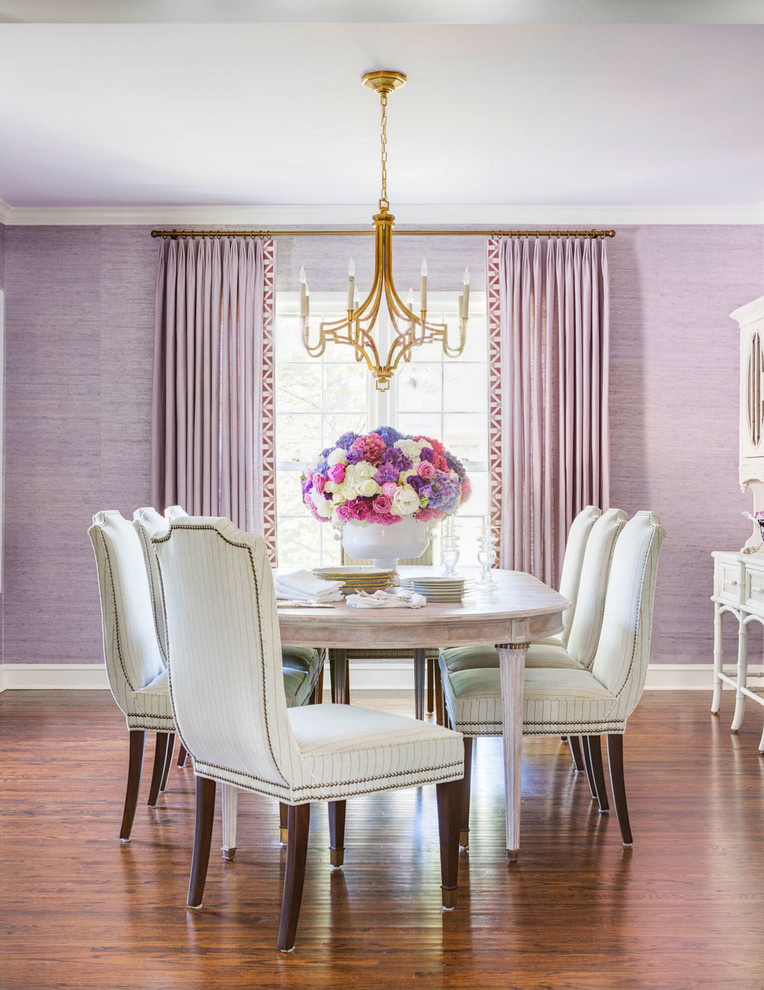 Mid-sized traditional dining room in Little Rock with purple walls and medium hardwood floors.