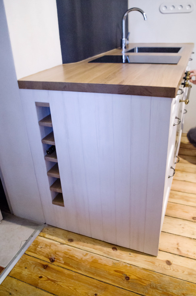 Inspiration for a small rustic single-wall kitchen remodel with an integrated sink and recessed-panel cabinets