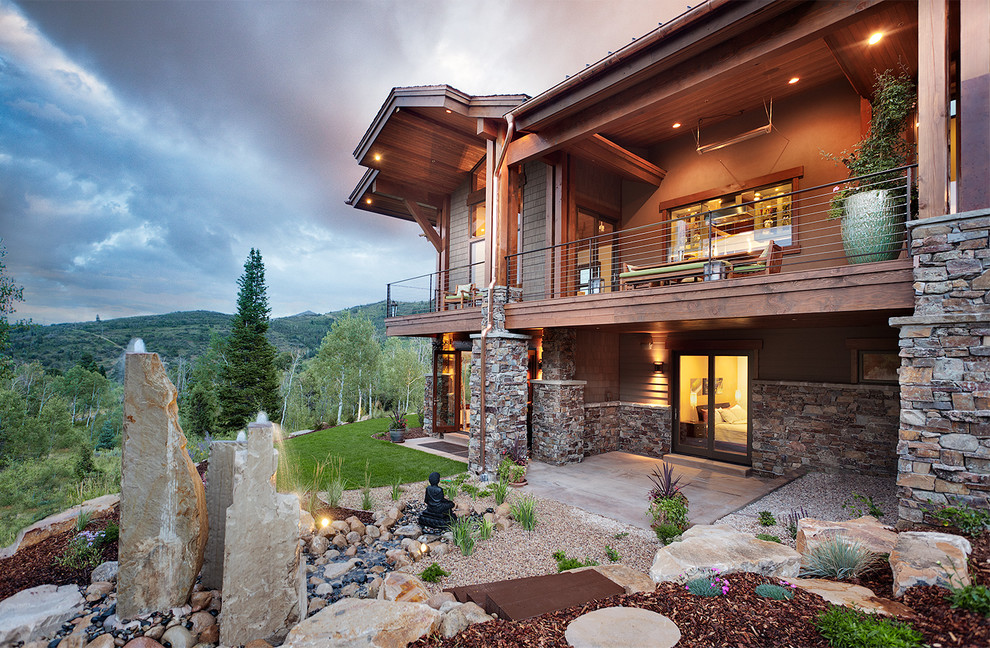 Design ideas for an expansive transitional two-storey brown house exterior in Salt Lake City with stone veneer, a flat roof and a metal roof.