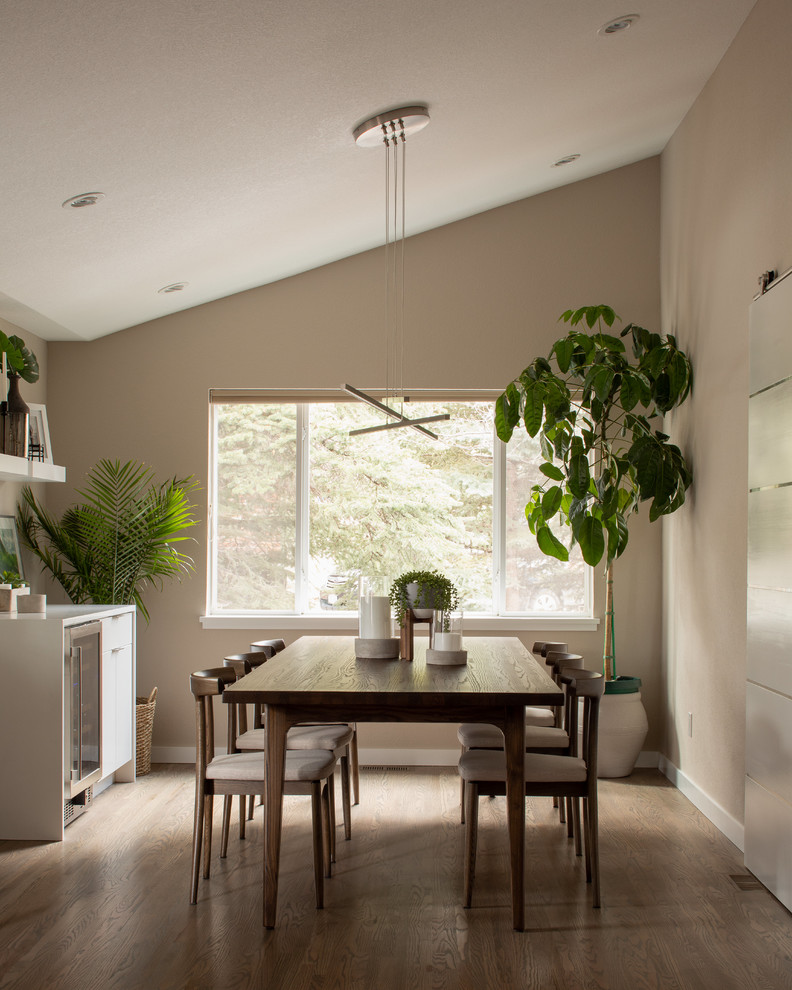 Inspiration for a mid-sized contemporary open plan dining in Denver with grey walls, medium hardwood floors, no fireplace and grey floor.