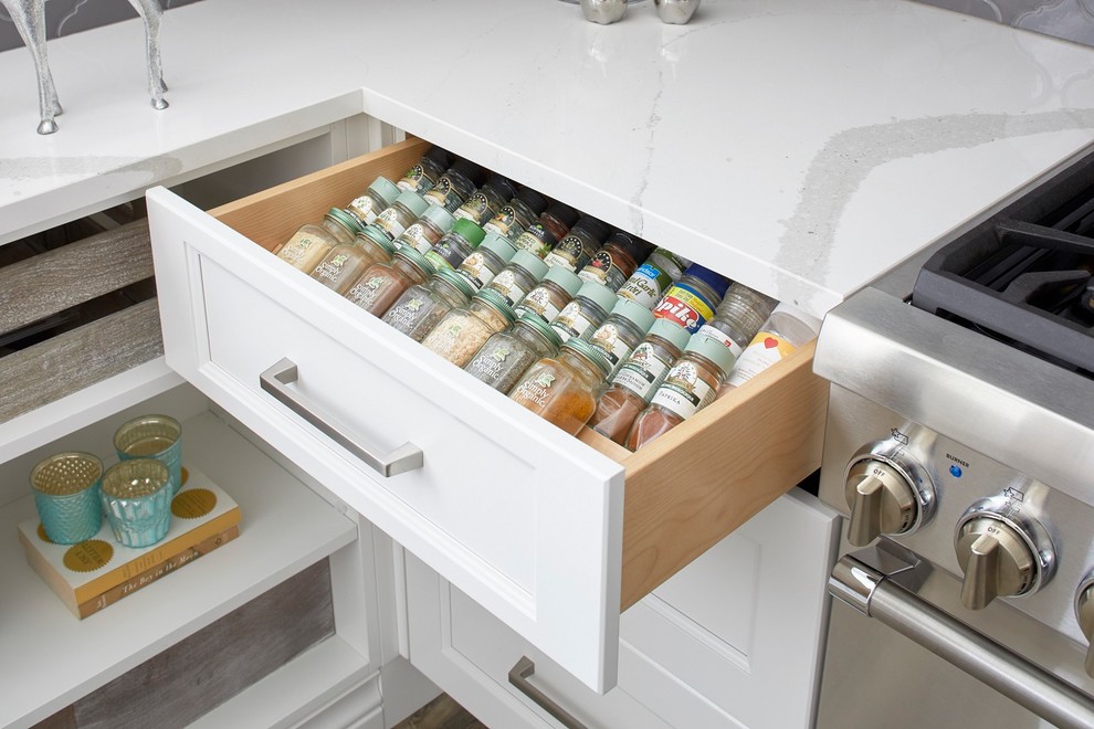 Example of a mid-sized transitional l-shaped light wood floor and multicolored floor eat-in kitchen design in Toronto with a farmhouse sink, shaker cabinets, dark wood cabinets, granite countertops, gray backsplash, stainless steel appliances, an island and white countertops