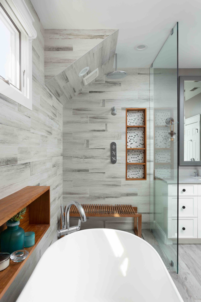 Inspiration for a mid-sized contemporary master bathroom in Chicago with furniture-like cabinets, grey cabinets, a freestanding tub, a curbless shower, a two-piece toilet, multi-coloured tile, porcelain tile, beige walls, porcelain floors, a drop-in sink, engineered quartz benchtops, beige floor, an open shower, beige benchtops, a shower seat, a double vanity and a freestanding vanity.