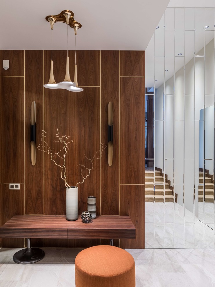 Photo of a contemporary entry hall in Moscow with white floor and brown walls.