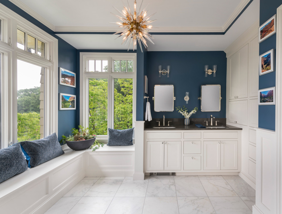 Design ideas for a large traditional master bathroom in Boston with shaker cabinets, white cabinets, a corner shower, blue walls, marble floors, an undermount sink, engineered quartz benchtops, white floor, a hinged shower door, black benchtops, an enclosed toilet, a double vanity, a built-in vanity and decorative wall panelling.
