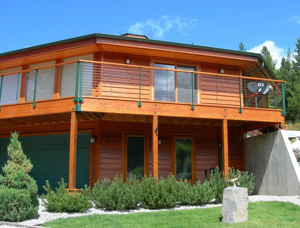 Deck - rustic backyard deck idea in Seattle with a roof extension