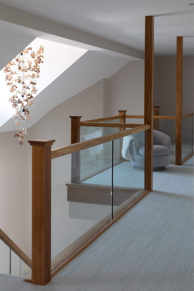 Photo of a contemporary hallway in Hertfordshire with carpet.