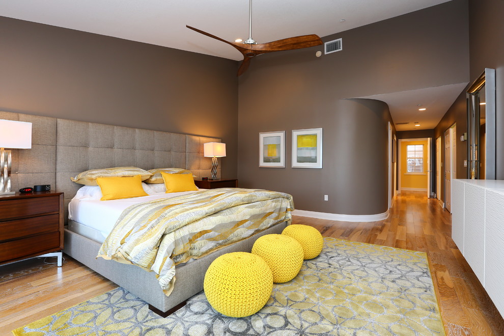 Inspiration for a contemporary bedroom in Tampa with brown walls, medium hardwood floors and yellow floor.