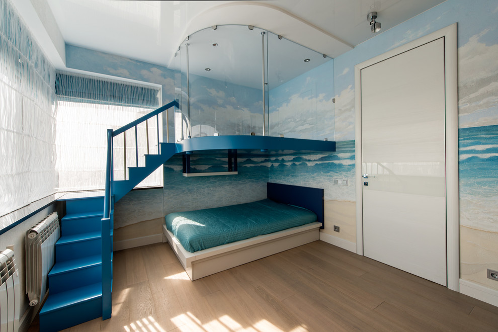 Photo of a beach style kids' room for kids 4-10 years old and boys in Moscow with blue walls and medium hardwood floors.