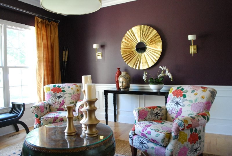 Small eclectic enclosed living room in St Louis with purple walls, light hardwood floors and no tv.