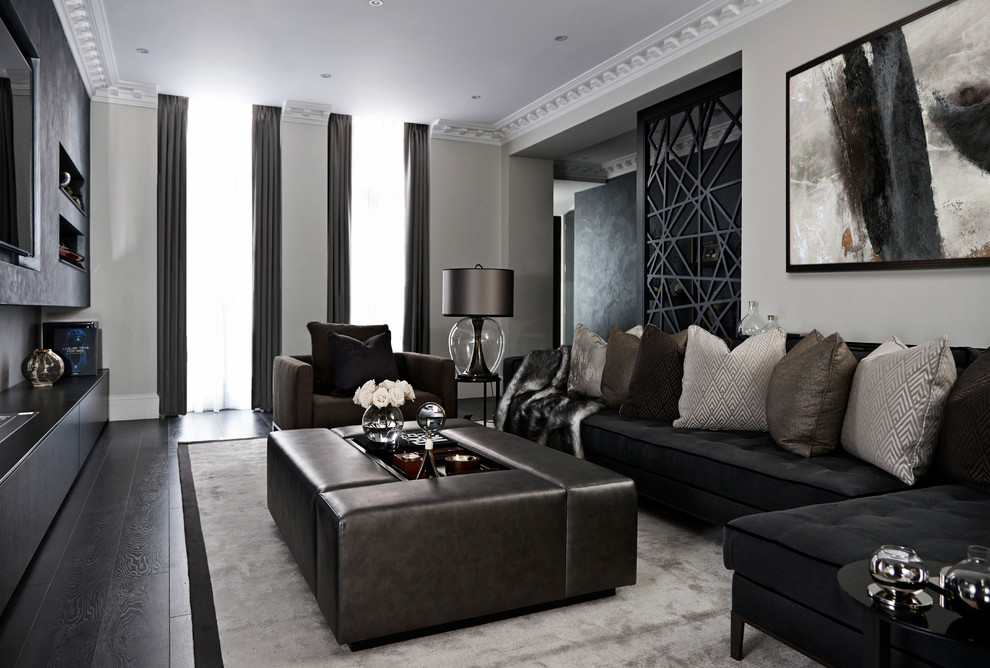 Photo of a contemporary formal living room in London with beige walls, dark hardwood floors, no fireplace and a wall-mounted tv.