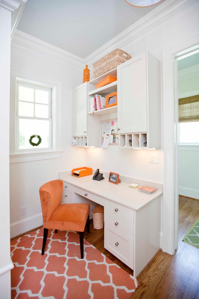 This is an example of a traditional home office in Charlotte with white walls.