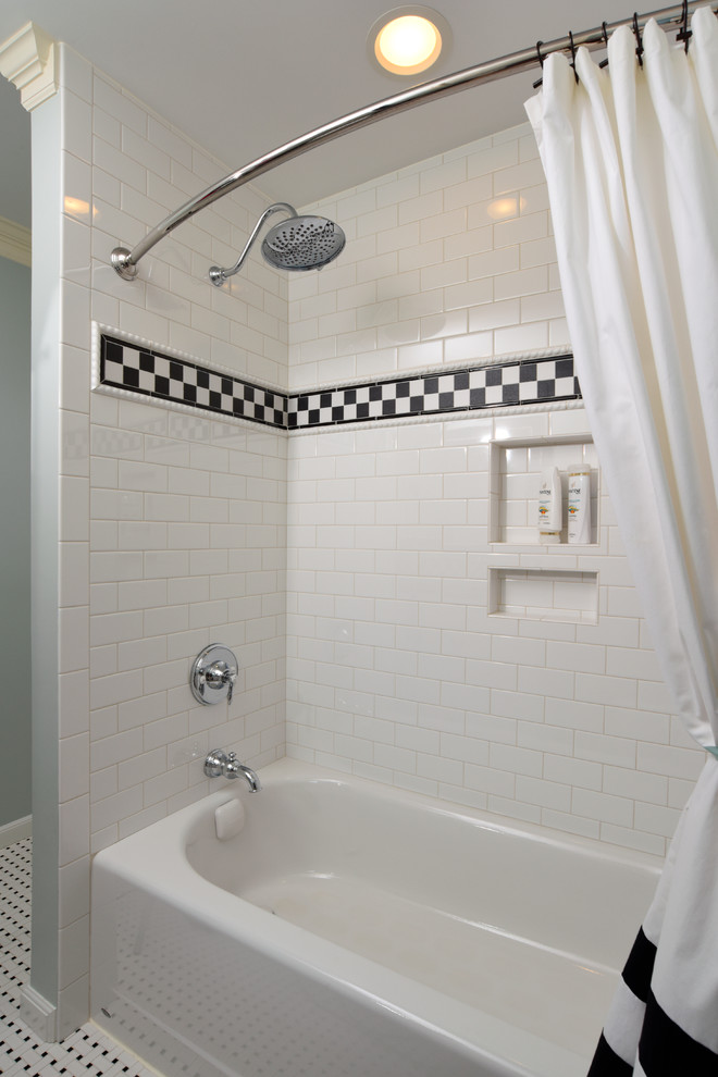 This is an example of a mid-sized traditional kids bathroom in Cincinnati with recessed-panel cabinets, white cabinets, an alcove tub, a shower/bathtub combo, a two-piece toilet, black and white tile, subway tile, blue walls, porcelain floors, an undermount sink and engineered quartz benchtops.
