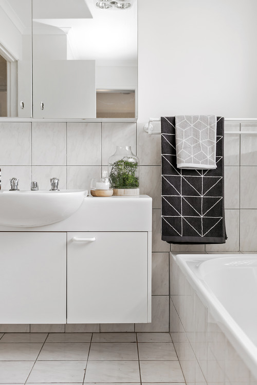 plain white bathroom with patterned towels