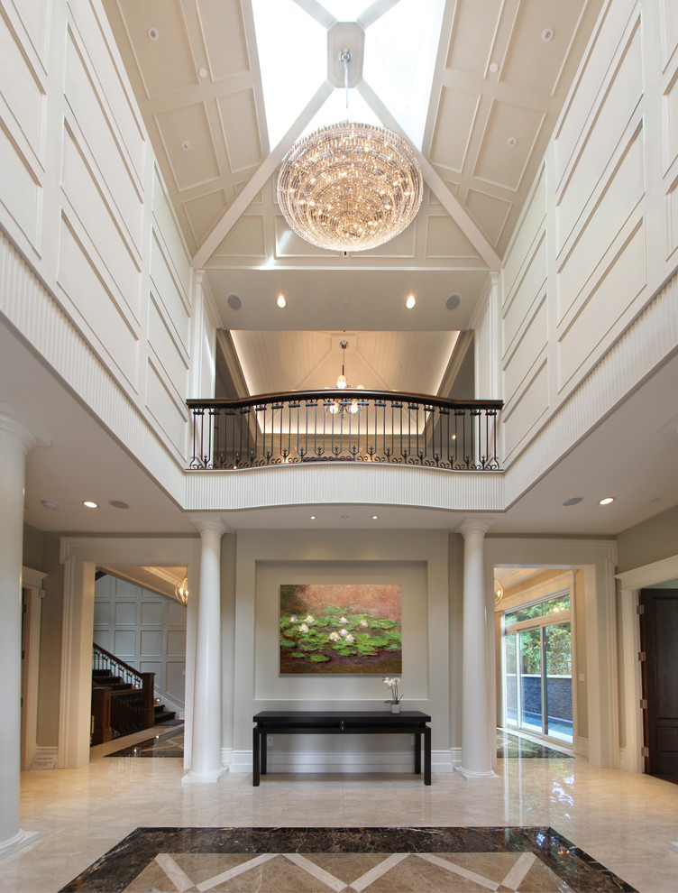 Design ideas for a large traditional entry hall in Vancouver with white walls and granite floors.