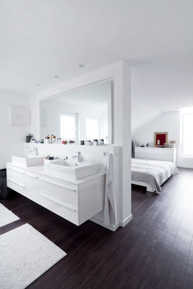 This is an example of a mid-sized contemporary master bathroom in Other with flat-panel cabinets, white cabinets, white walls, dark hardwood floors and a vessel sink.