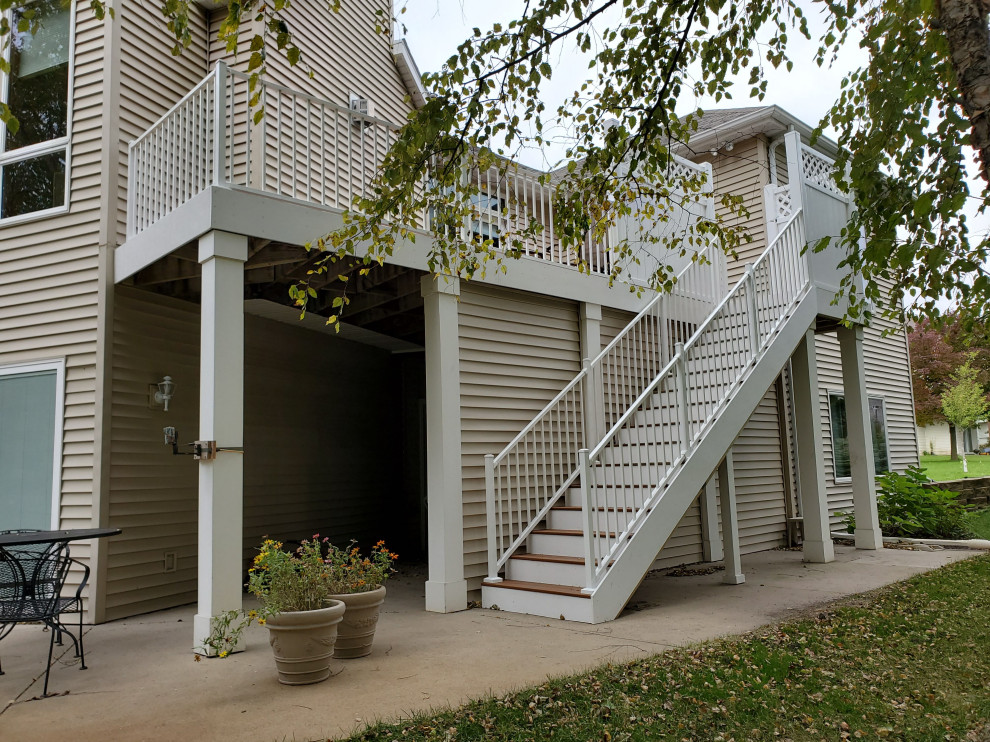 Example of a mid-sized backyard second story metal railing deck design with no cover