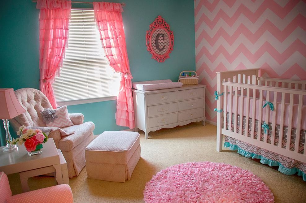 Small contemporary nursery in Atlanta with multi-coloured walls and carpet for girls.