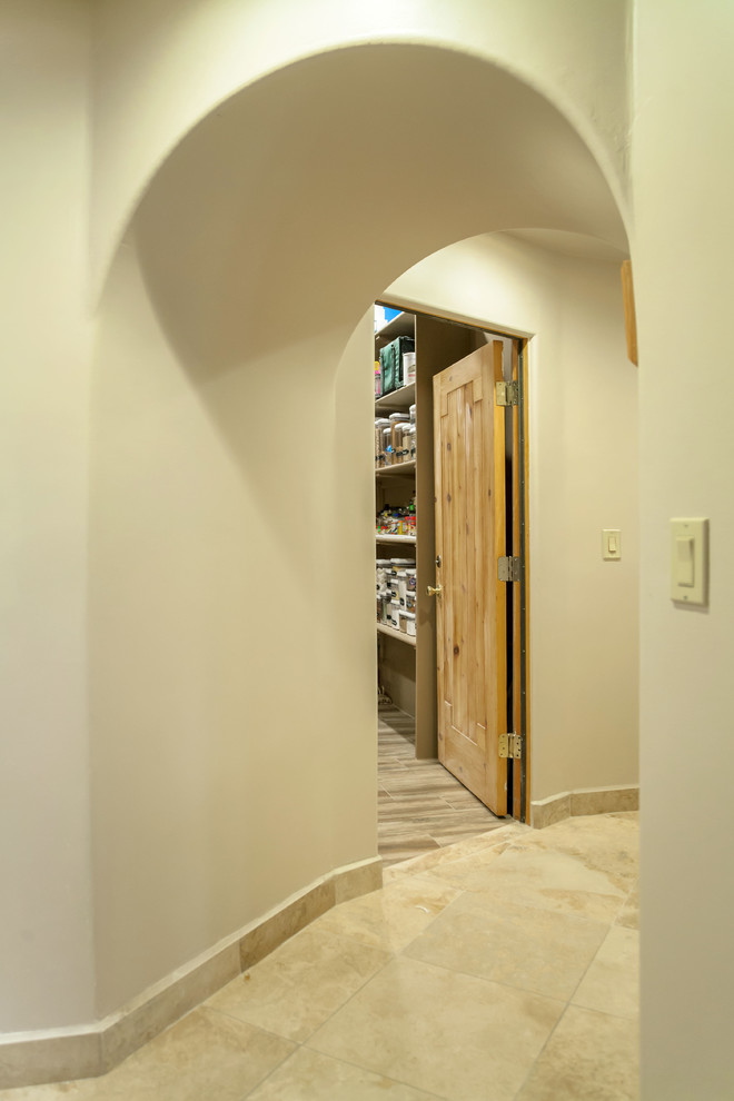 Inspiration for a transitional l-shaped ceramic tile home design remodel in Phoenix with an undermount sink, beaded inset cabinets, light wood cabinets, granite countertops, brown walls and a side-by-side washer/dryer
