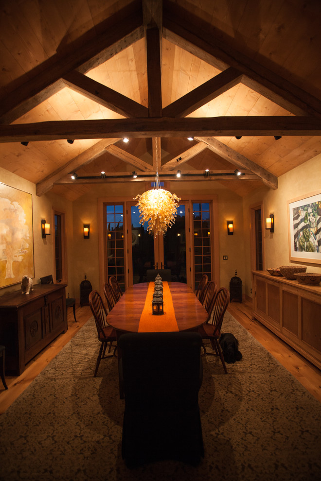 This is an example of an expansive country open plan dining in San Francisco with beige walls, light hardwood floors and brown floor.