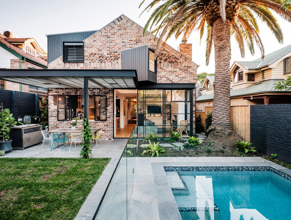 Mid-sized contemporary two-storey brick multi-coloured house exterior in Sydney with a gable roof and a metal roof.