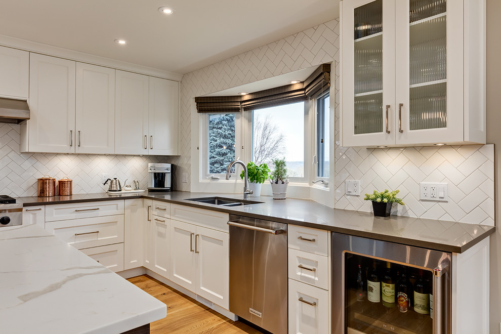 Example of a transitional kitchen design in Calgary