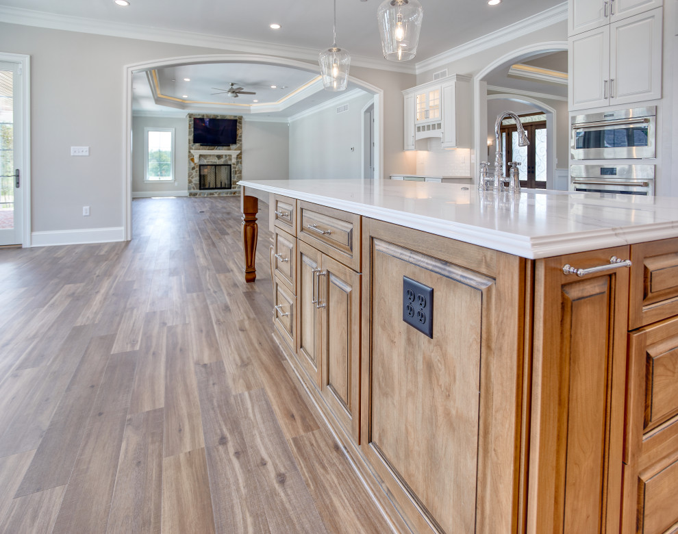 Transitional Kitchen with Two Toned Gathering Island & Archways