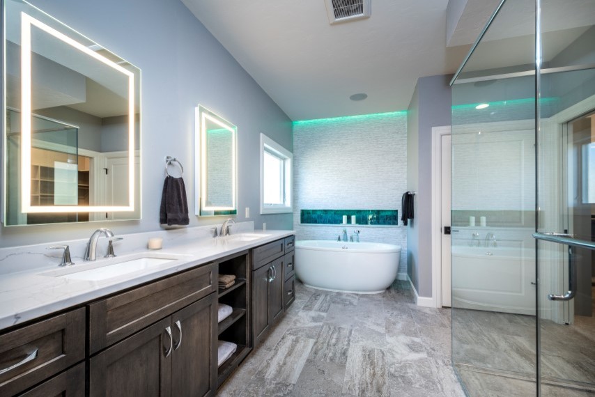 Photo of a mid-sized transitional master bathroom in Other with flat-panel cabinets, dark wood cabinets, a freestanding tub, a corner shower, white tile, ceramic floors, an undermount sink, quartzite benchtops, a hinged shower door and white benchtops.