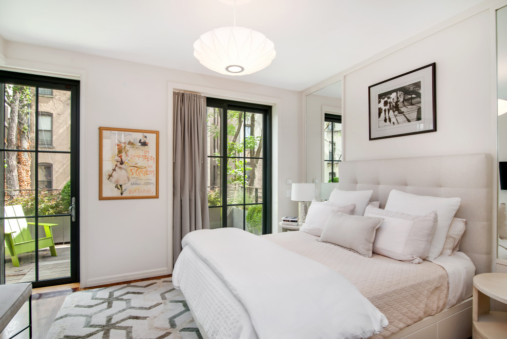 This is an example of a large contemporary master bedroom in New York with beige walls, medium hardwood floors and brown floor.