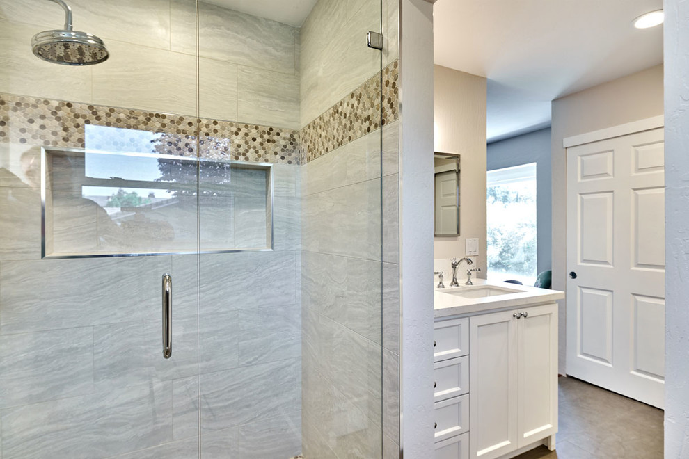 Example of a mid-sized transitional master beige tile and glass tile doorless shower design in San Francisco with shaker cabinets, white cabinets, a two-piece toilet, beige walls, an undermount sink and quartzite countertops