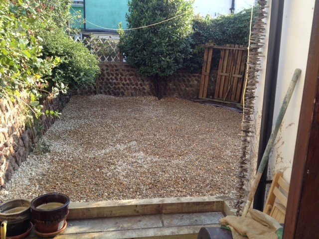 Inspiration for a mid-sized beach style courtyard partial sun xeriscape in Sussex with gravel.