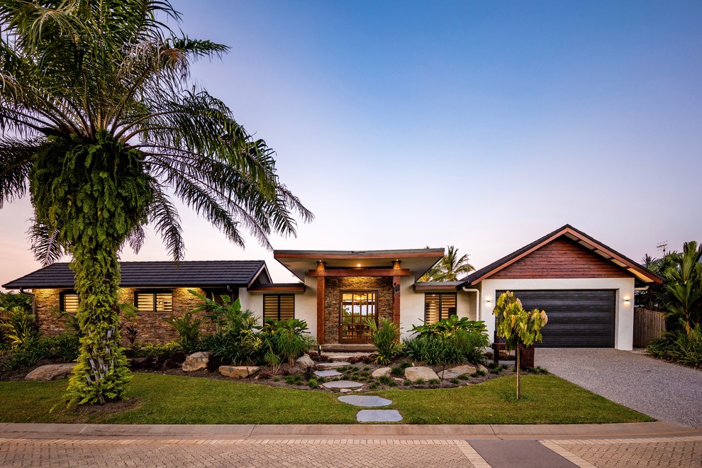 Tropical one-storey brown house exterior in Cairns with mixed siding, a gable roof and a shingle roof.