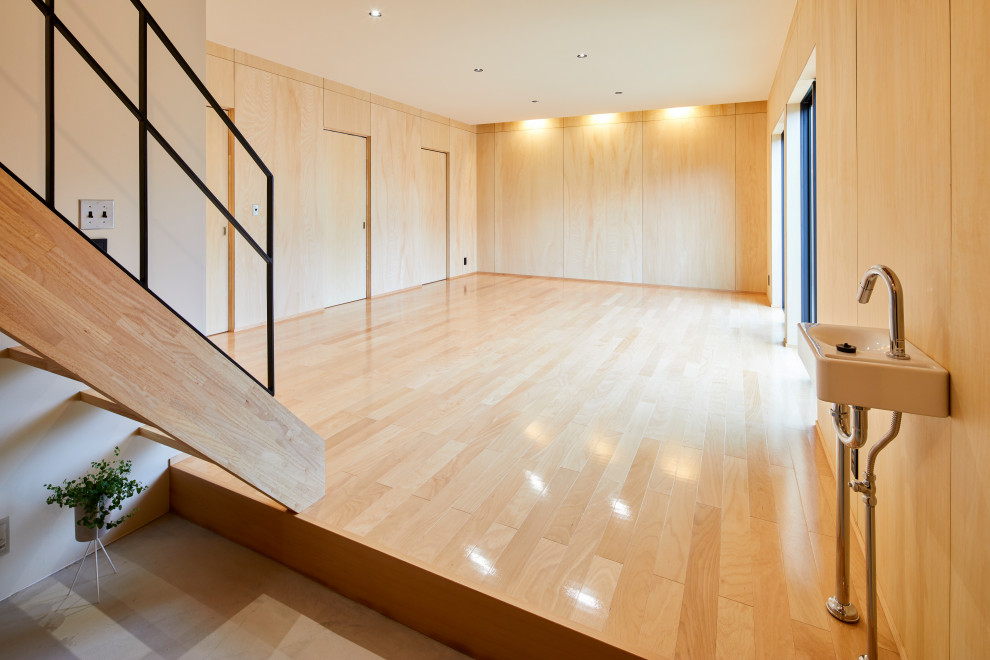Inspiration for a scandinavian multipurpose gym in Other with plywood floors and wallpaper.