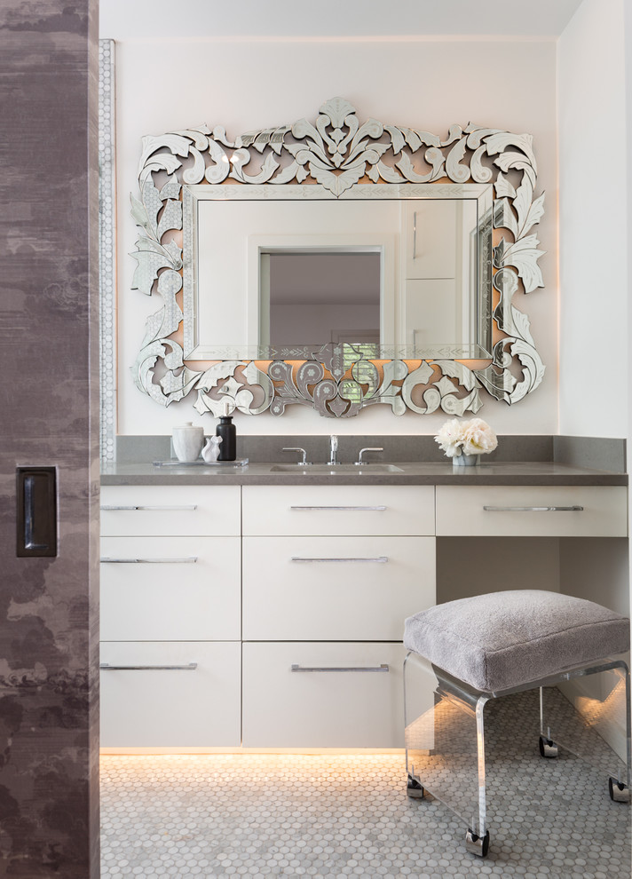 This is an example of a small contemporary master bathroom in Austin with an undermount sink, flat-panel cabinets, engineered quartz benchtops, a one-piece toilet, gray tile, stone tile, white walls, mosaic tile floors, white cabinets and grey benchtops.